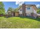 Manicured lawn in the backyard leads to an open covered patio space at 9270 Tennyson St, Westminster, CO 80031