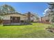 Manicured lawn in the backyard leads to an open covered patio space at 9270 Tennyson St, Westminster, CO 80031
