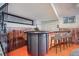 Basement bar features stone accents, a dark countertop, and wood paneling at 9270 Tennyson St, Westminster, CO 80031