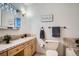Comfortable bathroom featuring ceramic tile, a vanity, sink, and ample lighting at 9270 Tennyson St, Westminster, CO 80031
