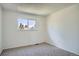Clean, carpeted bedroom with a large window providing ample natural light at 9270 Tennyson St, Westminster, CO 80031
