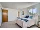 Bright bedroom with plush carpeting, a large window, and soothing color accents at 9270 Tennyson St, Westminster, CO 80031