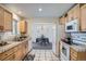 Open kitchen with light wood cabinets, view to dining, and white appliances, perfect for cooking at 9270 Tennyson St, Westminster, CO 80031