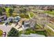 Aerial view of home in neighborhood with mature trees and green space with walking path at 9521 Joyce Ln, Highlands Ranch, CO 80126