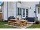 Back patio seating area with a wooden picnic table, grill, and flowers at 9521 Joyce Ln, Highlands Ranch, CO 80126