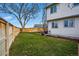 Spacious backyard with a wood fence and a picnic table on a green lawn at 9521 Joyce Ln, Highlands Ranch, CO 80126