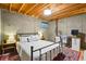 Basement bedroom has exposed ceiling with a full size bed and an area for a home office at 9521 Joyce Ln, Highlands Ranch, CO 80126