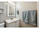 Bright bathroom featuring a modern sink vanity with an illuminated mirror and soft blue hand towels at 9521 Joyce Ln, Highlands Ranch, CO 80126