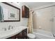 Bathroom with a sink vanity and cabinet paired with a shower-tub combination featuring a floral shower curtain at 9521 Joyce Ln, Highlands Ranch, CO 80126