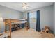 Bedroom with lofted bed, shelving, natural light, and playful rocking chair at 9521 Joyce Ln, Highlands Ranch, CO 80126