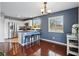 View of the kitchen and dining area with hardwood floors and natural light from a large window at 9521 Joyce Ln, Highlands Ranch, CO 80126