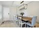 Dining area with modern chandelier, table for six, and tiled entry at 9521 Joyce Ln, Highlands Ranch, CO 80126