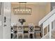 Dining room with modern lighting, seating for six, and open view to the foyer at 9521 Joyce Ln, Highlands Ranch, CO 80126