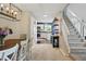 Inviting dining room flowing into kitchen, featuring modern chandelier and staircase at 9521 Joyce Ln, Highlands Ranch, CO 80126
