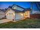 Charming two-story home featuring an attached two-car garage and well-manicured front yard at 9521 Joyce Ln, Highlands Ranch, CO 80126