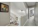 Carpeted upstairs hallway featuring a railing and access to bedrooms at 9521 Joyce Ln, Highlands Ranch, CO 80126