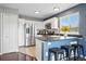 Bright kitchen features white cabinets, stainless steel appliances and a breakfast bar with seating at 9521 Joyce Ln, Highlands Ranch, CO 80126