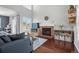 Bright living room featuring vaulted ceiling, brick fireplace, and stylish furniture at 9521 Joyce Ln, Highlands Ranch, CO 80126