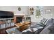 Cozy living area with brick fireplace, dark wood floors, and lots of natural light at 9521 Joyce Ln, Highlands Ranch, CO 80126