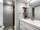 Modern bathroom with custom wood shelving, sink, vanity and door to shower/toilet at 384 S Ironton St # 408, Aurora, CO 80012