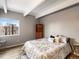 Bright bedroom with a large window, comfortable bed, and exposed beam ceiling at 384 S Ironton St # 408, Aurora, CO 80012