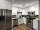 Modern kitchen featuring stainless steel appliances, sleek white cabinetry, and stylish countertops at 384 S Ironton St # 408, Aurora, CO 80012