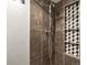Close-up of shower with decorative tile niche and bronze fixture at 384 S Ironton St # 408, Aurora, CO 80012