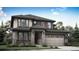 Charming two-story home with stone accents, a covered porch, an attached two car garage, and professional landscaping at 12779 Glasgow Pl, Littleton, CO 80127