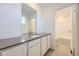 Well-lit bathroom featuring a single vanity sink, modern fixtures, and a separate door to the tub and shower at 739 N Deer Park St, Watkins, CO 80137