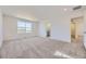 Spacious bedroom with carpeted floors, neutral walls, bright natural light, and an ensuite bathroom at 739 N Deer Park St, Watkins, CO 80137
