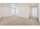 Bright, carpeted bedroom with a large window and neutral walls, offering a serene and comfortable living space at 739 N Deer Park St, Watkins, CO 80137