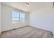 Comfortable bedroom featuring neutral walls, carpeted floors, a large window with natural light, and ventilation at 739 N Deer Park St, Watkins, CO 80137