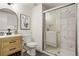 Updated bathroom with sleek vanity, stylish mirror, and modern glass-enclosed shower at 3643 S Mobile Way, Aurora, CO 80013