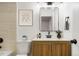 Stylish bathroom with a wooden vanity, modern fixtures, and a framed decorative print at 3643 S Mobile Way, Aurora, CO 80013
