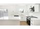 Bright kitchen featuring white cabinetry, quartz countertops, and stainless steel appliances at 3643 S Mobile Way, Aurora, CO 80013