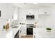 Modern kitchen with stainless steel appliances, white cabinets, and quartz countertops at 3643 S Mobile Way, Aurora, CO 80013
