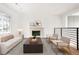 Bright living room featuring a cozy fireplace, modern furniture, and hardwood floors at 3643 S Mobile Way, Aurora, CO 80013