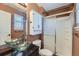 Bathroom with glass bowl sinks and shower with sliding glass door at 18347 E Nassau Dr, Aurora, CO 80013