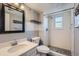 Renovated bathroom featuring a subway tile shower, a modern sink, and decorative shelving at 18347 E Nassau Dr, Aurora, CO 80013