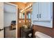 Bathroom featuring a glass bowl sink and cabinet providing storage space at 18347 E Nassau Dr, Aurora, CO 80013