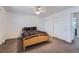 Bedroom features a light wood frame bed, ceiling fan and double-door closets at 18347 E Nassau Dr, Aurora, CO 80013