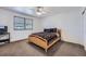 Bedroom showcases a light wood bed frame, neutral walls, ceiling fan and window at 18347 E Nassau Dr, Aurora, CO 80013