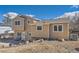 Rear view of a two-story home featuring a well-maintained yard and mature landscaping at 18347 E Nassau Dr, Aurora, CO 80013