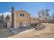 Charming two-story home with a brick chimney, a cozy patio, and a well-maintained backyard at 18347 E Nassau Dr, Aurora, CO 80013