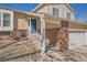 Welcoming front entrance with brick accents and a vibrant blue door, leading to a well-maintained home at 18347 E Nassau Dr, Aurora, CO 80013