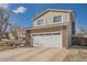 Inviting two-story home showcasing a brick facade and attached two-car garage with a well-maintained lawn at 18347 E Nassau Dr, Aurora, CO 80013