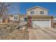 Charming two-story home with brick accents, attached garage, and landscaped front yard under a clear blue sky at 18347 E Nassau Dr, Aurora, CO 80013