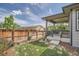 Fenced backyard featuring a covered patio and grassy lawn at 4343 E 96Th Way, Thornton, CO 80229