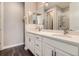 Bathroom with double sink vanity with dark fixtures, white countertop and white cabinets at 4343 E 96Th Way, Thornton, CO 80229