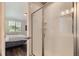 Modern bathroom featuring a glass-enclosed shower and view of a bedroom through the doorway at 4343 E 96Th Way, Thornton, CO 80229